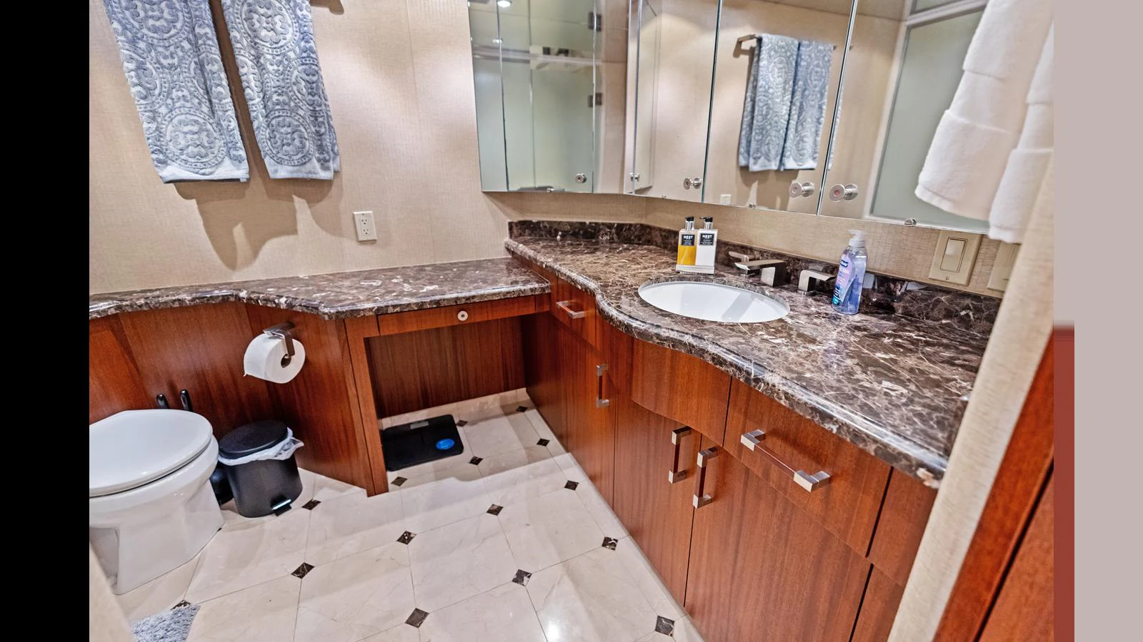 The yacht's bathroom features elegant marble countertops and ample storage space. aboard FIRTH'S CHASM Yacht for Sale