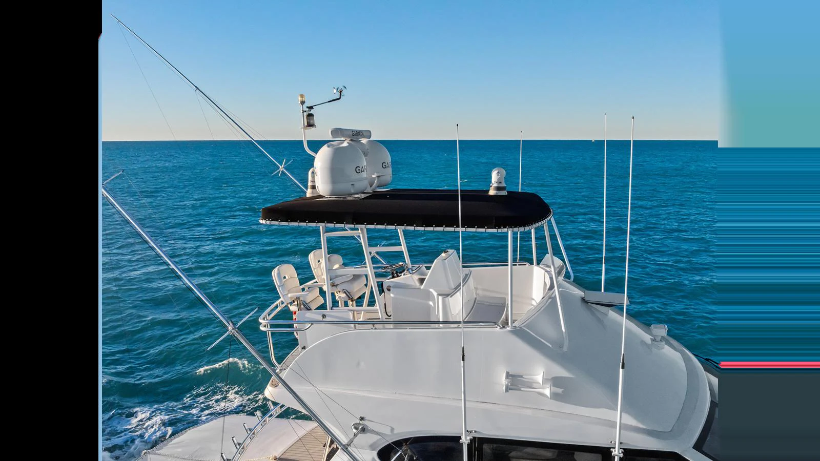 The yacht's flybridge offers a commanding view of the open sea, equipped with seating and navigational equipment. aboard FIRTH'S CHASM Yacht for Sale