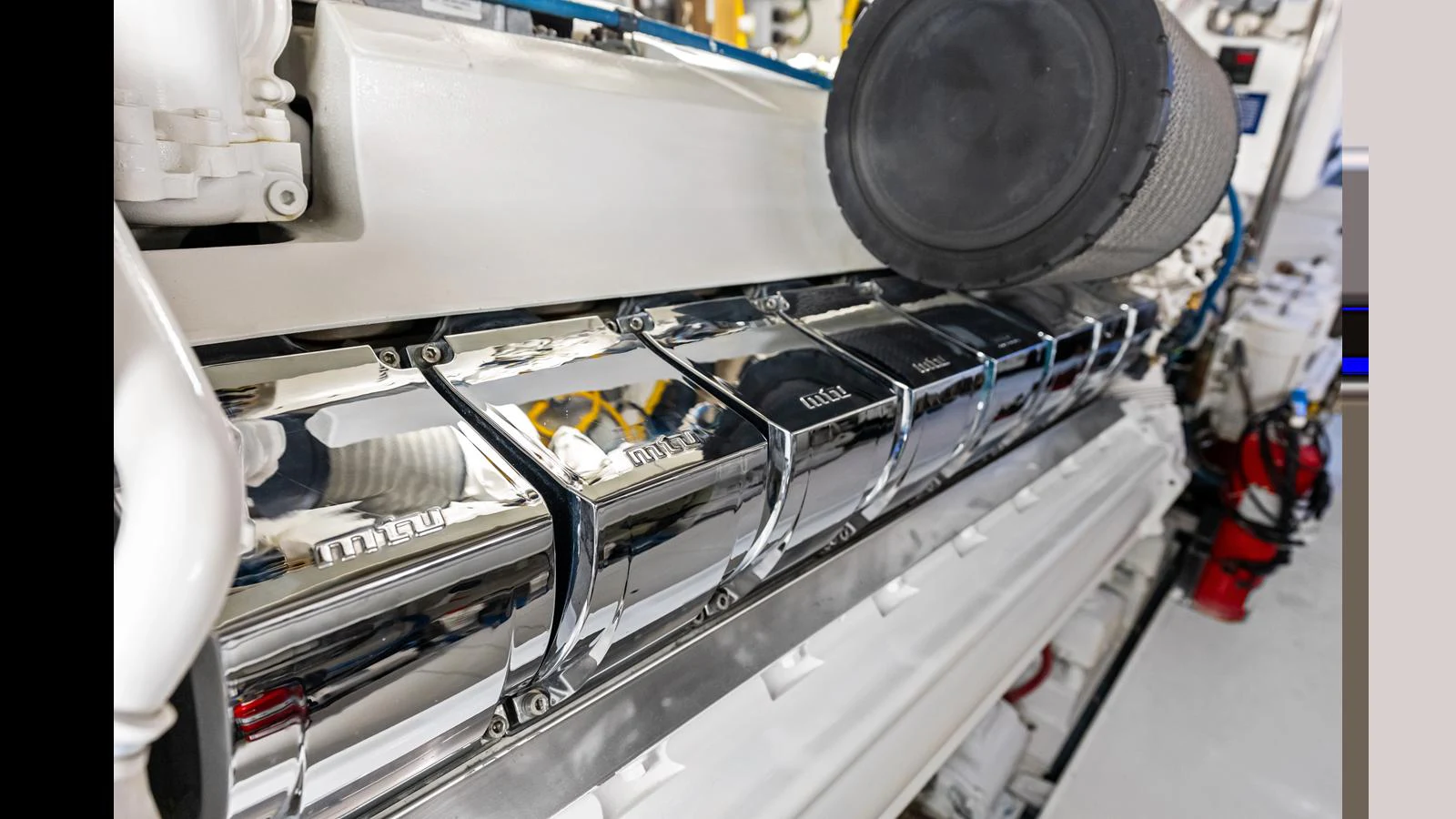 A close-up view of the yacht's engine room showcasing the polished engine components. aboard FIRTH'S CHASM Yacht for Sale