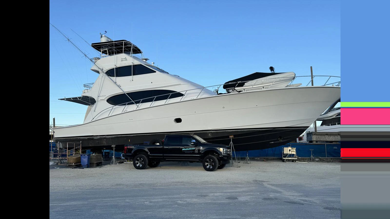 A sleek yacht is docked on land, showcasing its impressive size and modern design. aboard FIRTH'S CHASM Yacht for Sale