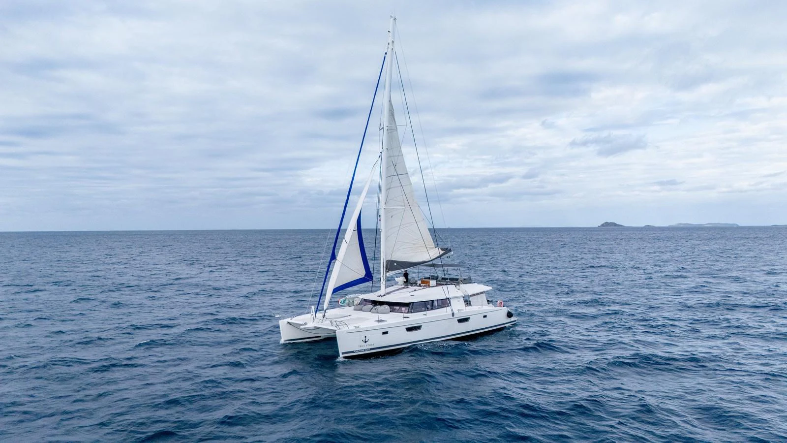 a white boat in the water aboard TRUE STORY Yacht for Sale