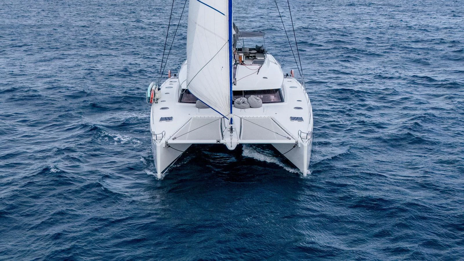 a white boat in the water aboard TRUE STORY Yacht for Sale
