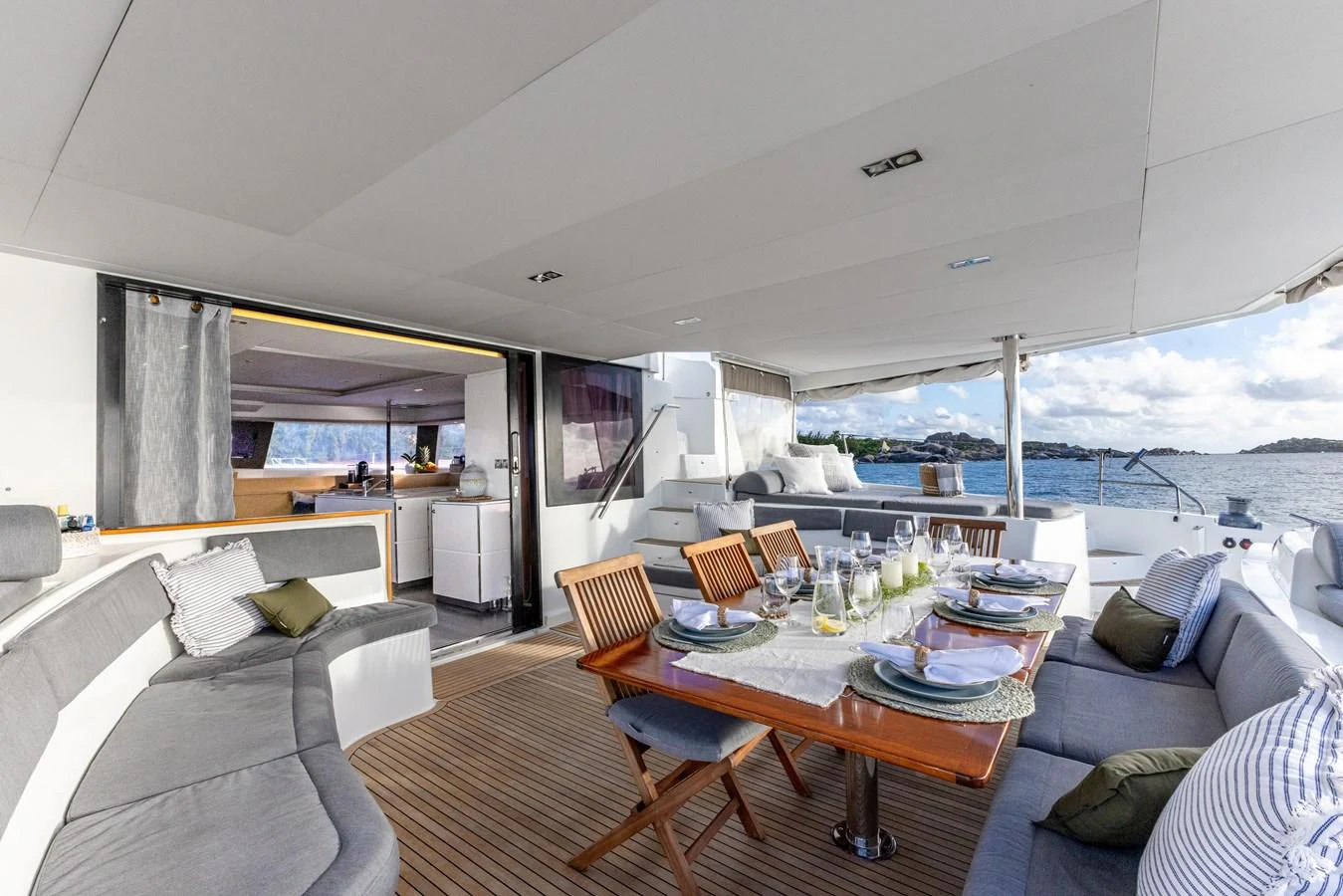 a living room with a couch and a table aboard TRUE STORY Yacht for Sale