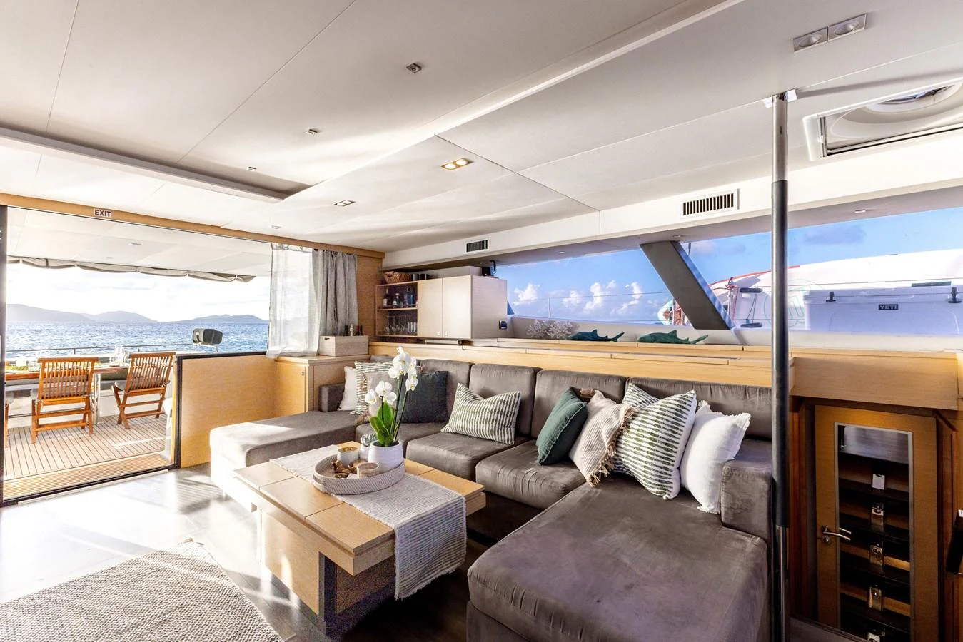 a living room with a couch and a table aboard TRUE STORY Yacht for Sale