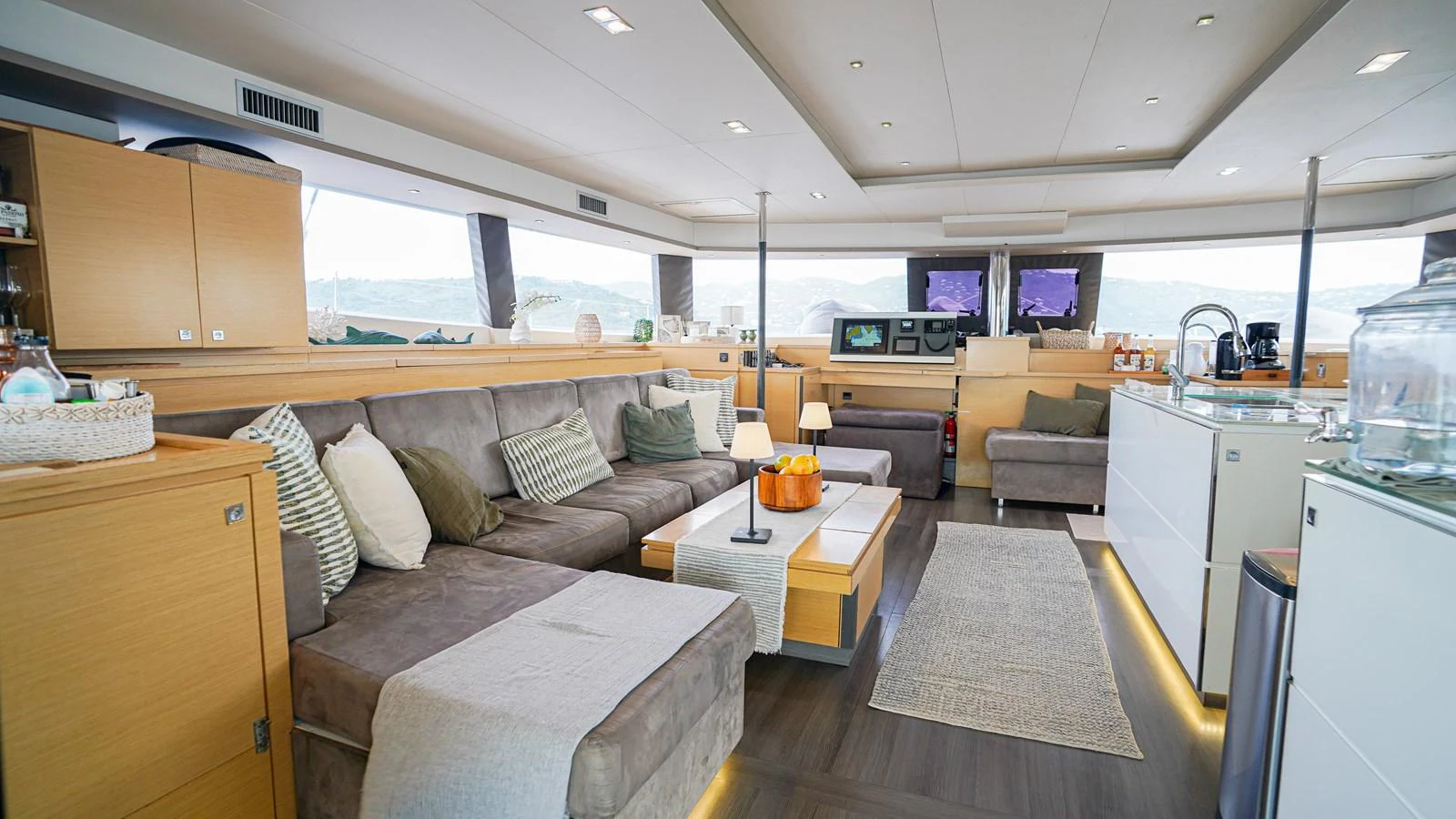 a living room with a couch and a table aboard TRUE STORY Yacht for Sale