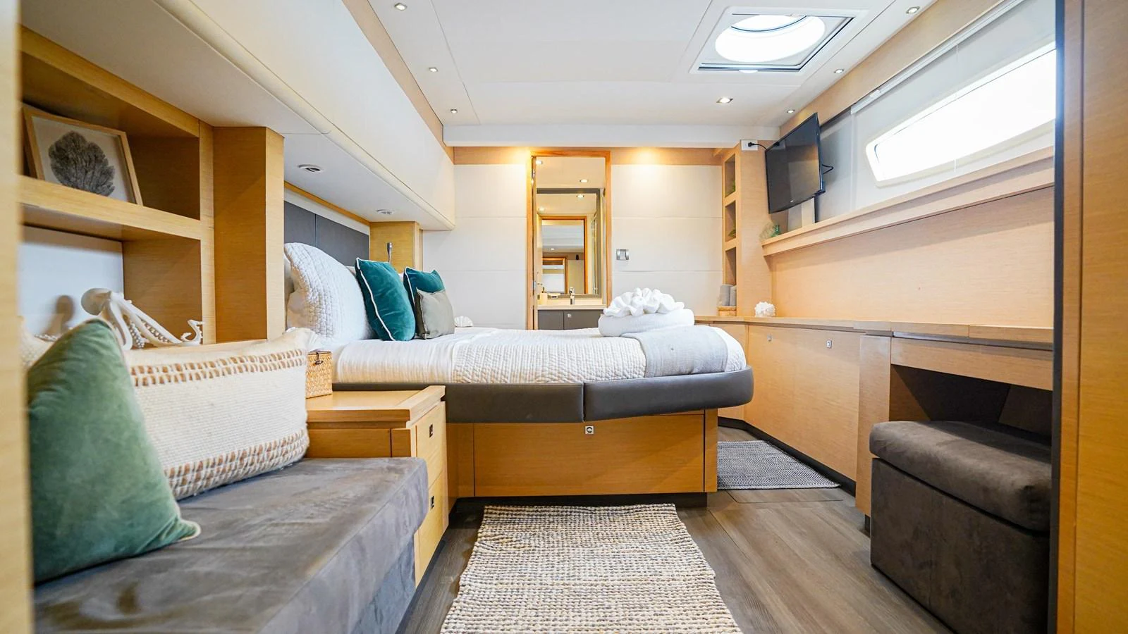 a room with a bed and a couch aboard TRUE STORY Yacht for Sale