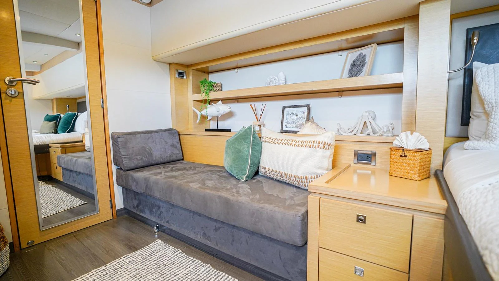 a living room with a couch and a mirror aboard TRUE STORY Yacht for Sale