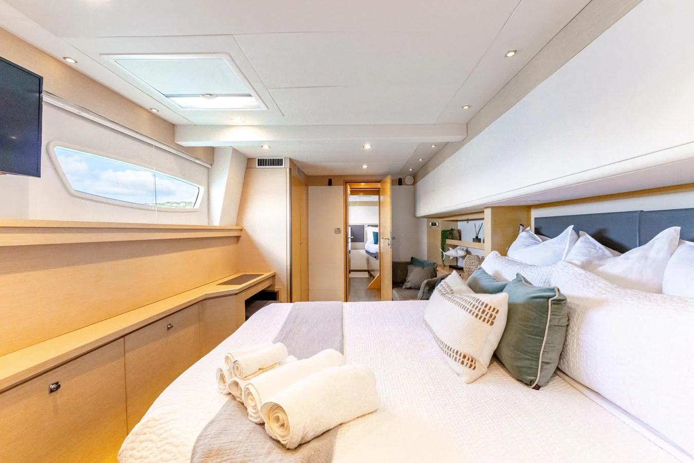 a room with a bed and a desk aboard TRUE STORY Yacht for Sale