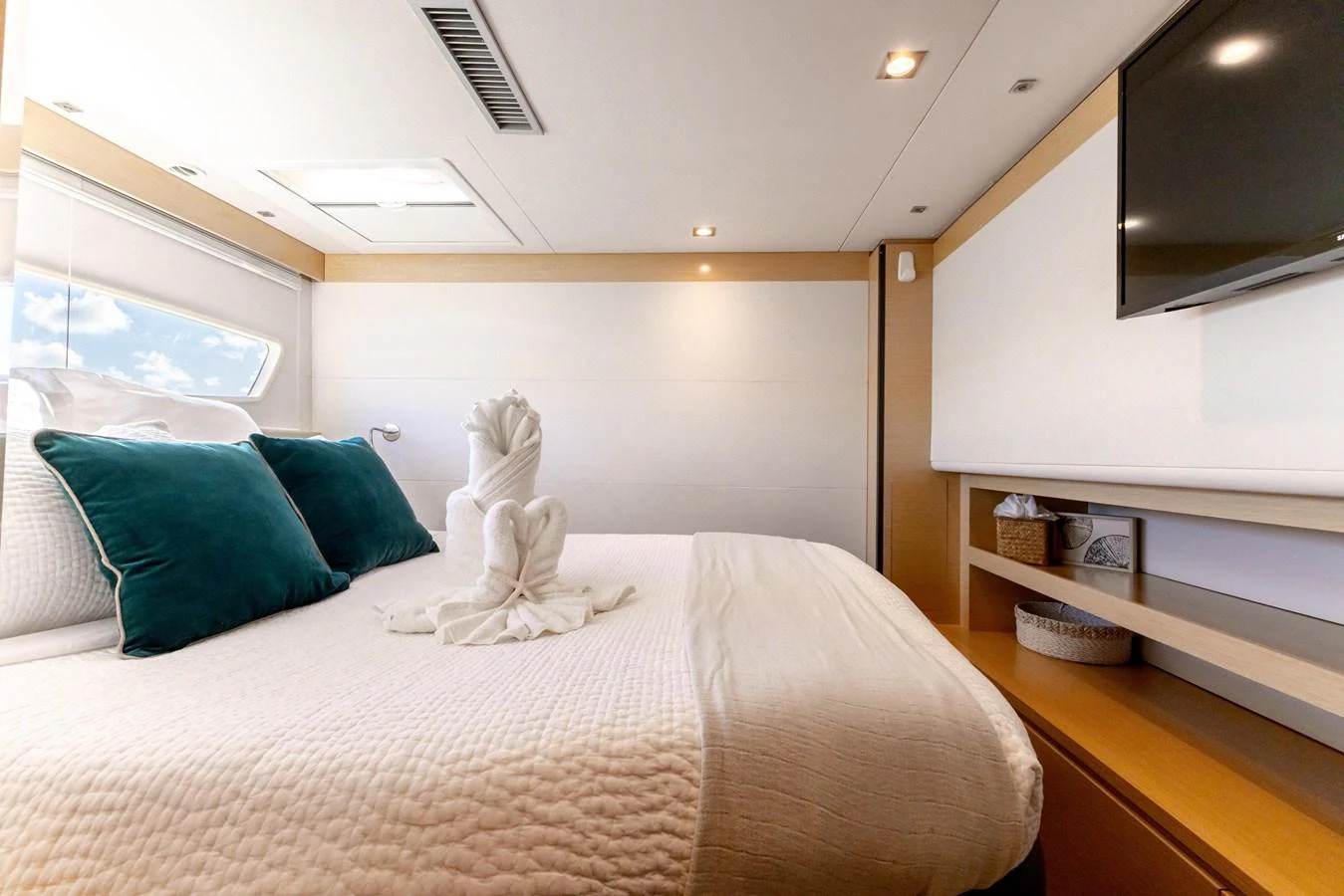 a white stuffed animal on a bed aboard TRUE STORY Yacht for Sale