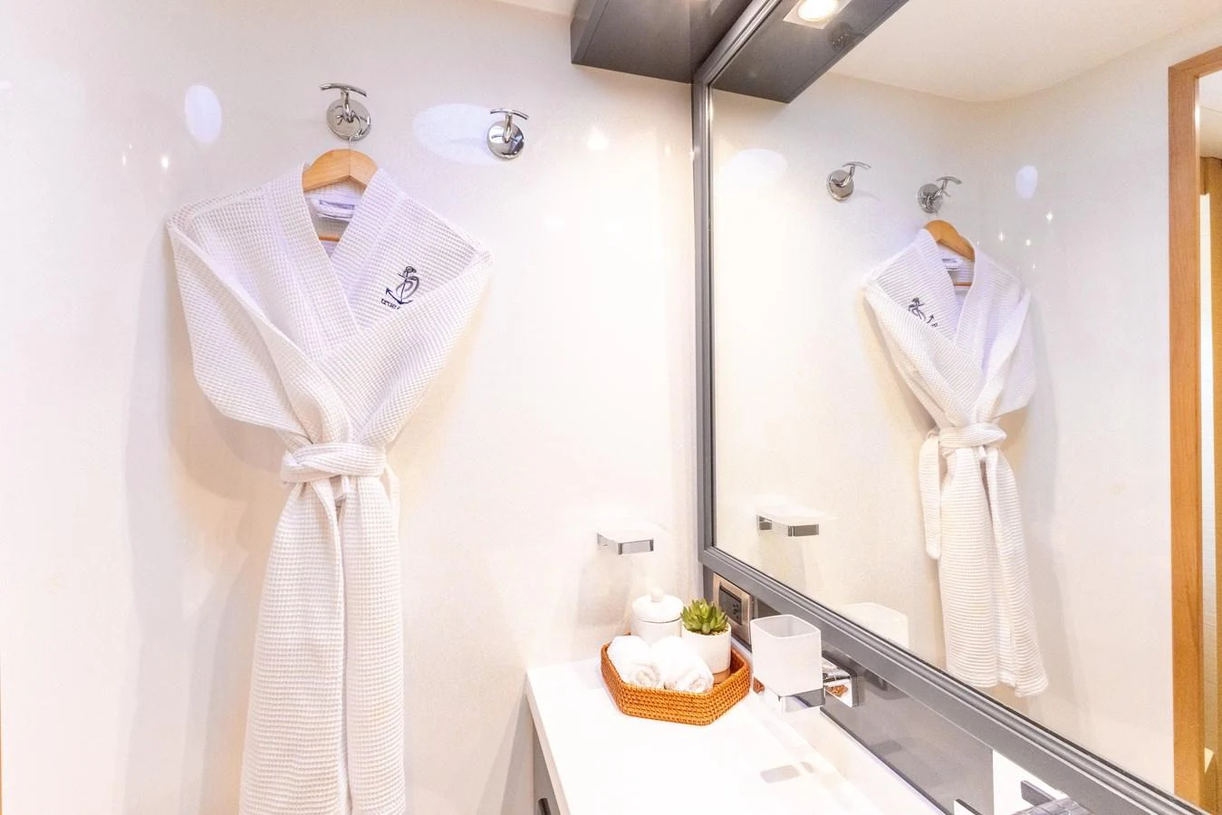 a bathroom with a robe on the wall aboard TRUE STORY Yacht for Sale