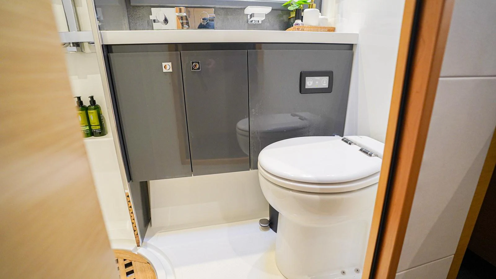a bathroom with a toilet and a sink aboard TRUE STORY Yacht for Sale