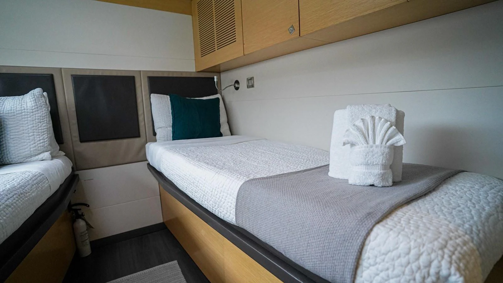 a couple of beds in a room aboard TRUE STORY Yacht for Sale
