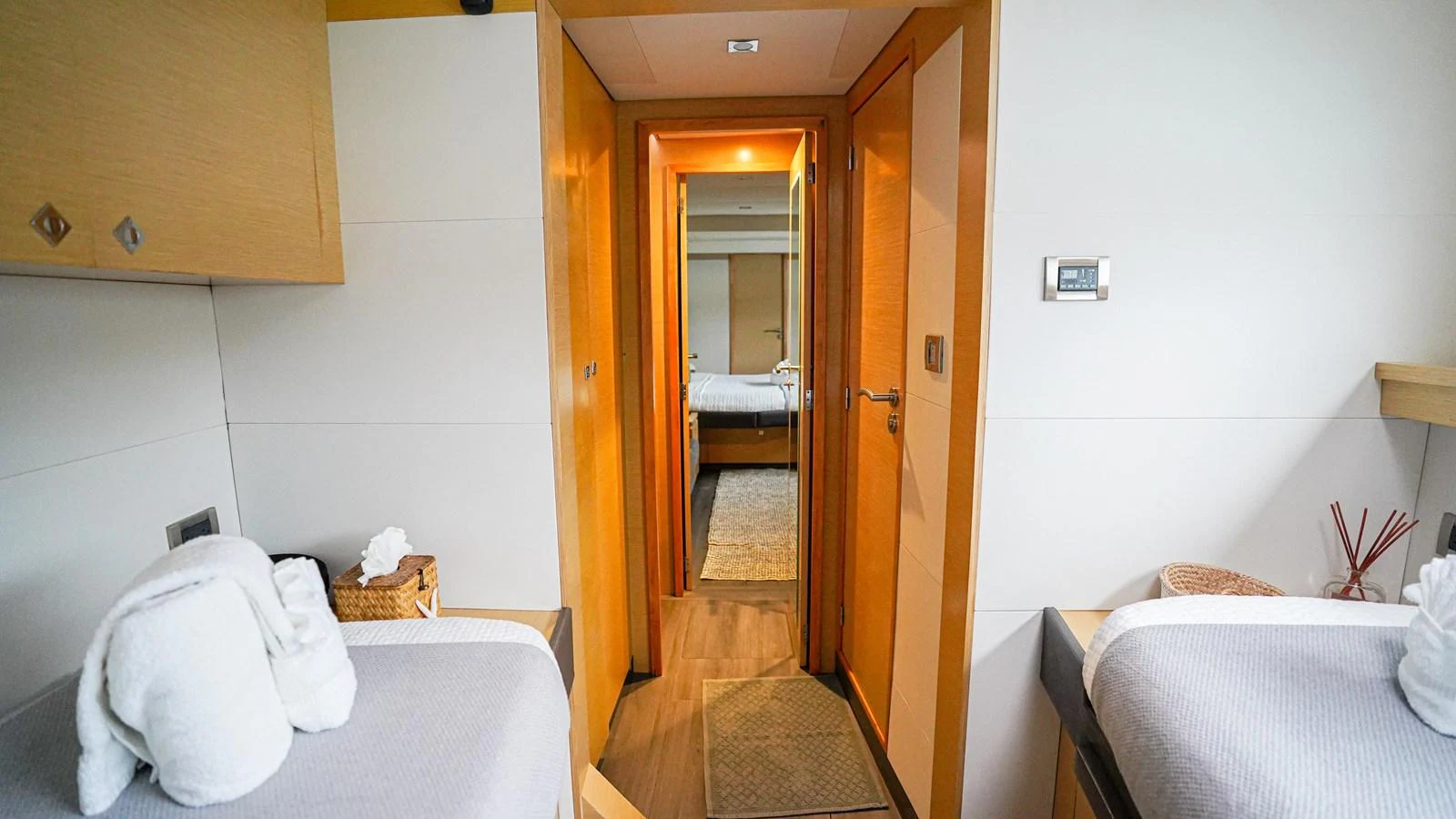 a room with a bed and a door aboard TRUE STORY Yacht for Sale
