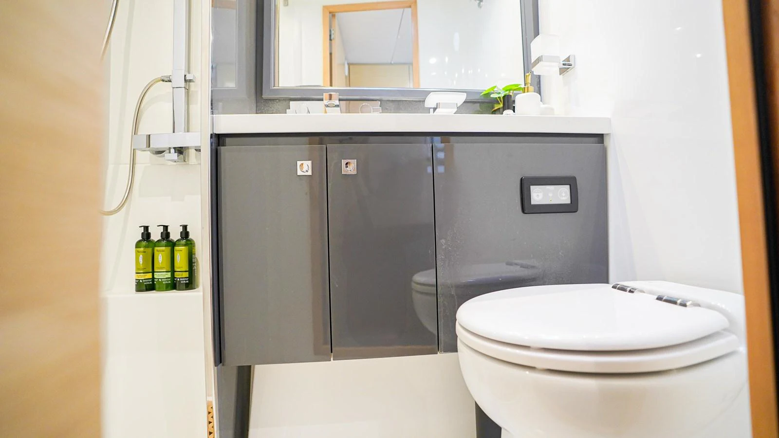 a bathroom with a toilet and a shower unit aboard TRUE STORY Yacht for Sale