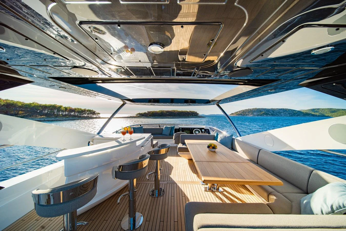 The aft deck features a spacious and stylish dining area with panoramic views of the sea. aboard BLACK MAMBA Yacht for Sale