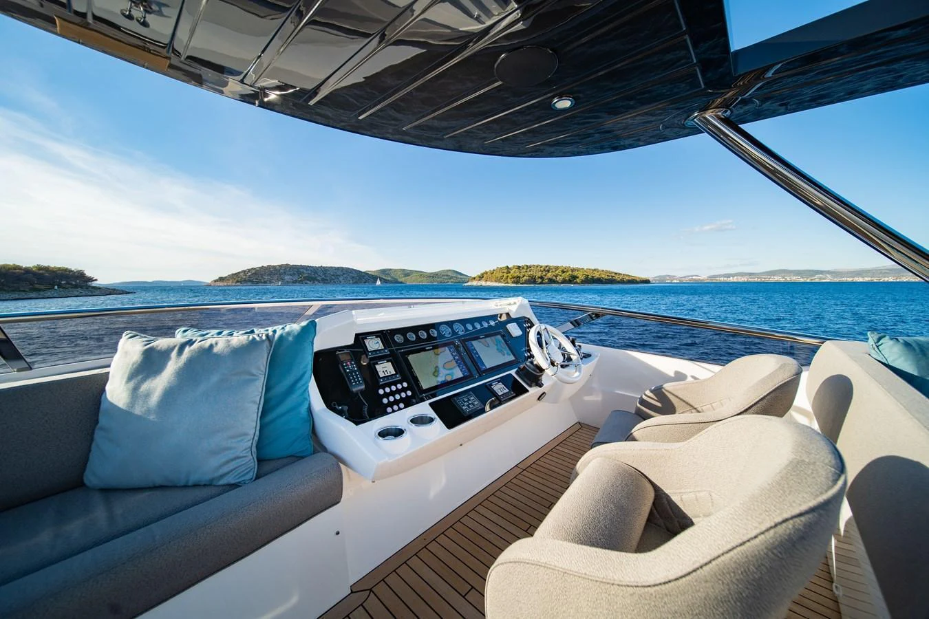 The helm station offers a panoramic view with plush seating and state-of-the-art navigation equipment. aboard BLACK MAMBA Yacht for Sale