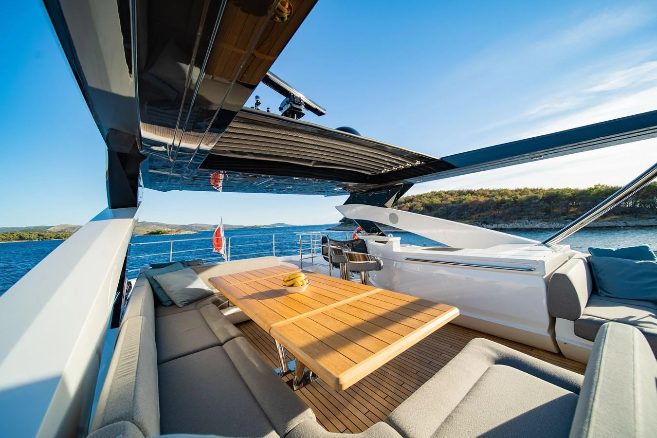 The flybridge offers a spacious and luxurious outdoor dining area with stunning views. aboard BLACK MAMBA Yacht for Sale
