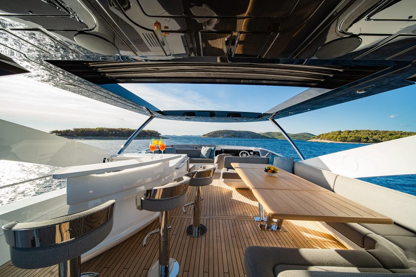 The flybridge offers a spacious and luxurious area for dining and relaxation with stunning views of the surrounding waters. aboard BLACK MAMBA Yacht for Sale