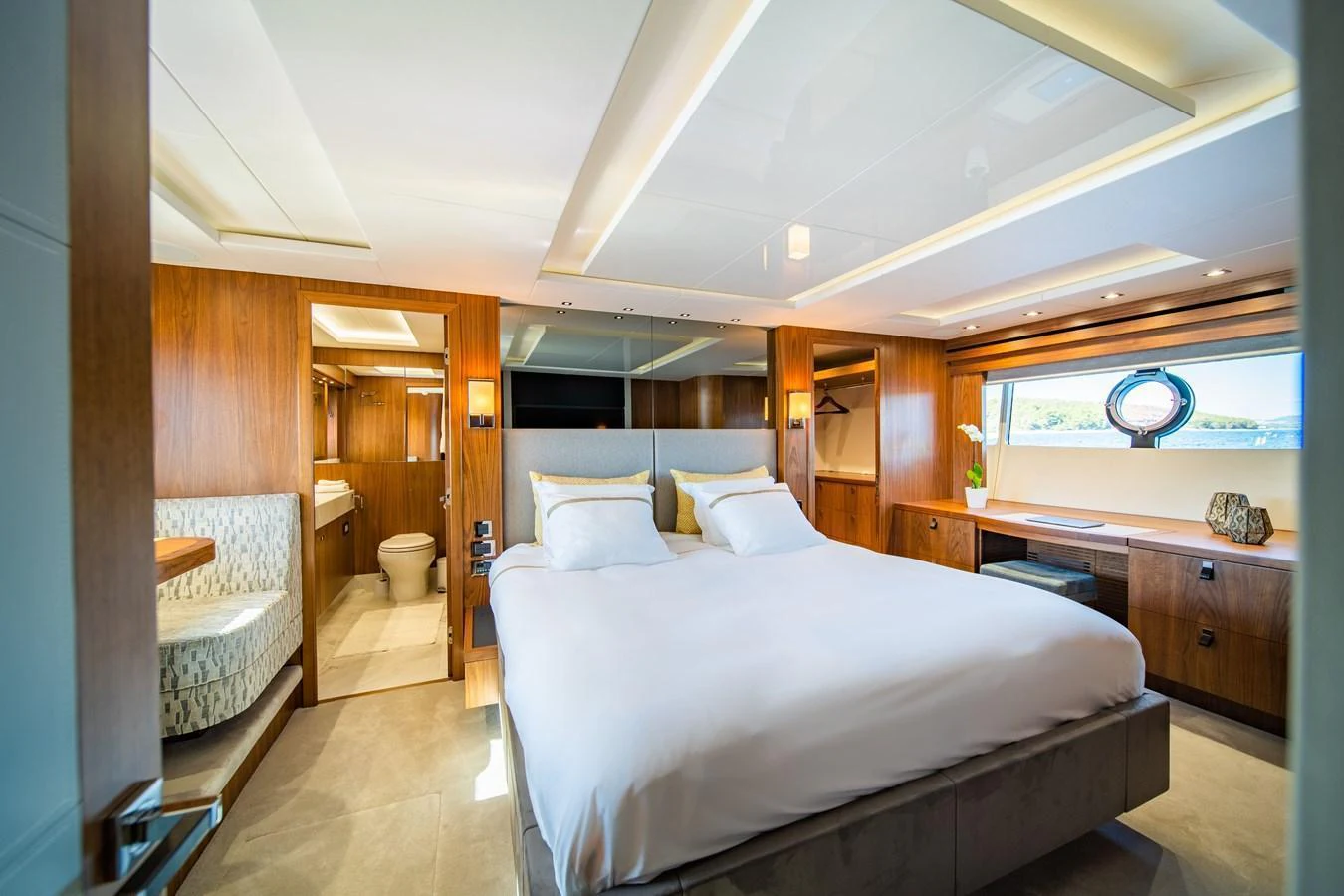 The master stateroom offers a spacious and luxurious retreat with elegant wood finishes and ample natural light. aboard BLACK MAMBA Yacht for Sale