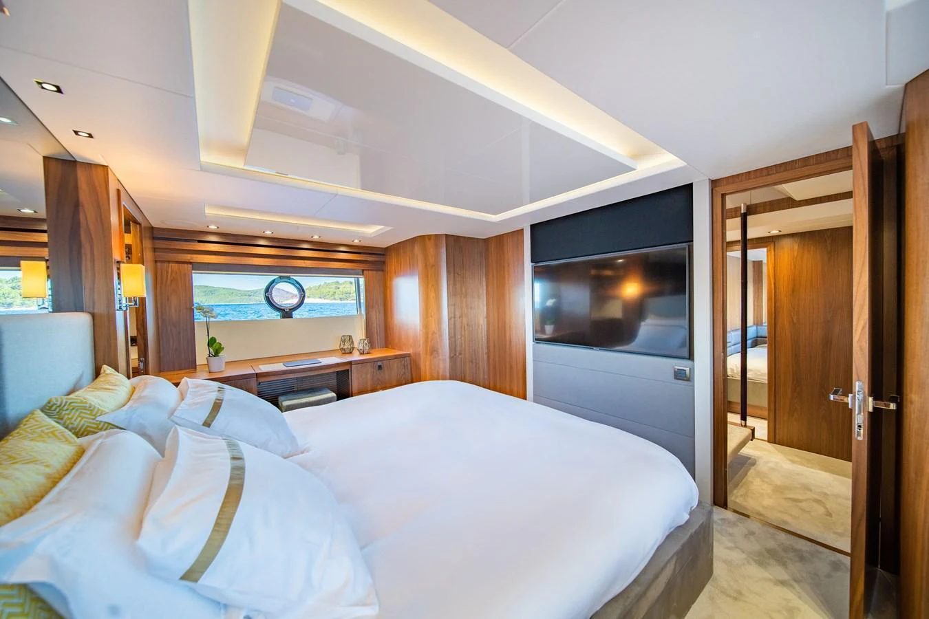 The master stateroom features a luxurious bed, modern decor, and ample natural light. aboard BLACK MAMBA Yacht for Sale