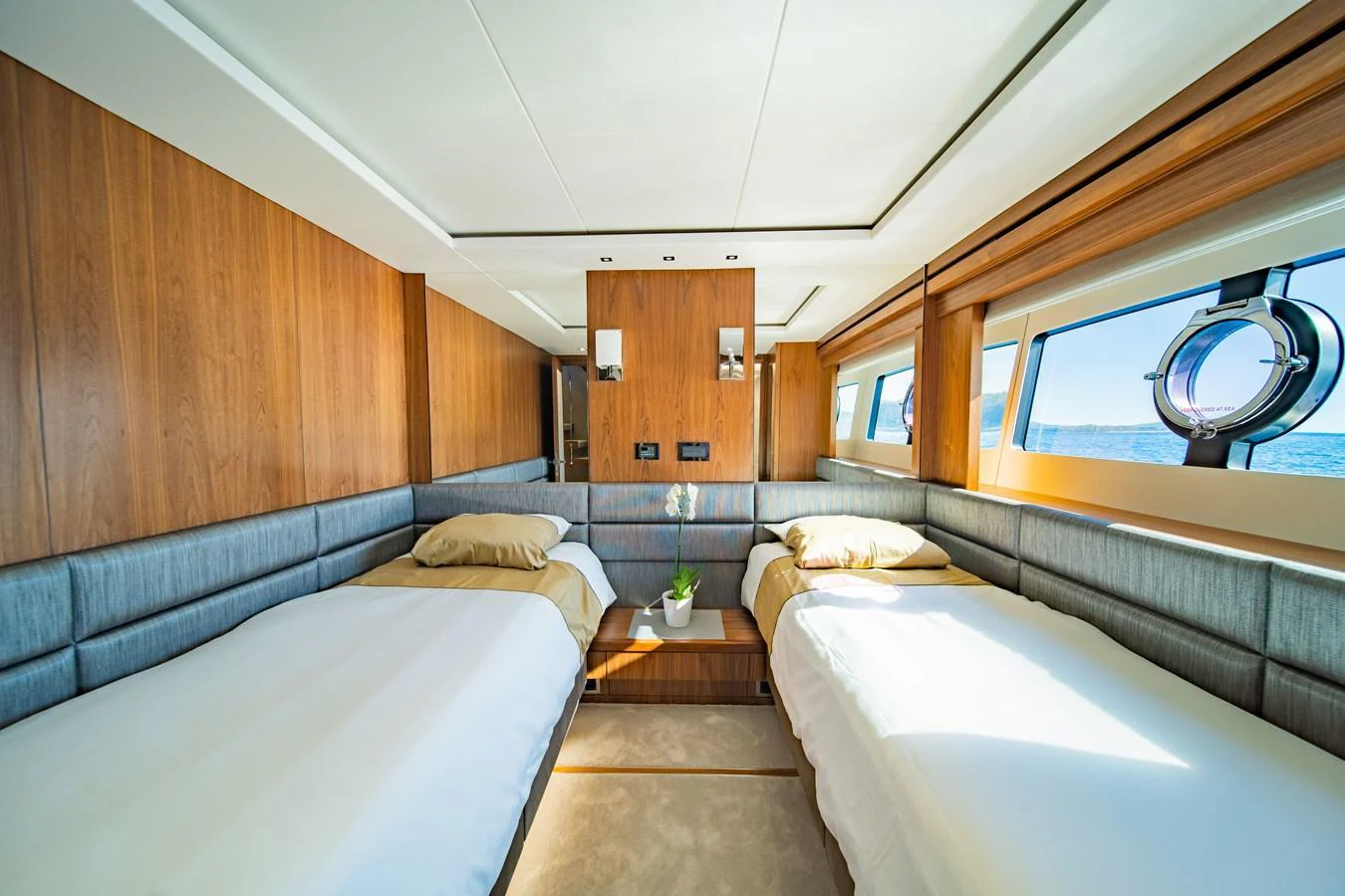 The twin stateroom features two comfortable beds with ample natural light from large windows. aboard BLACK MAMBA Yacht for Sale
