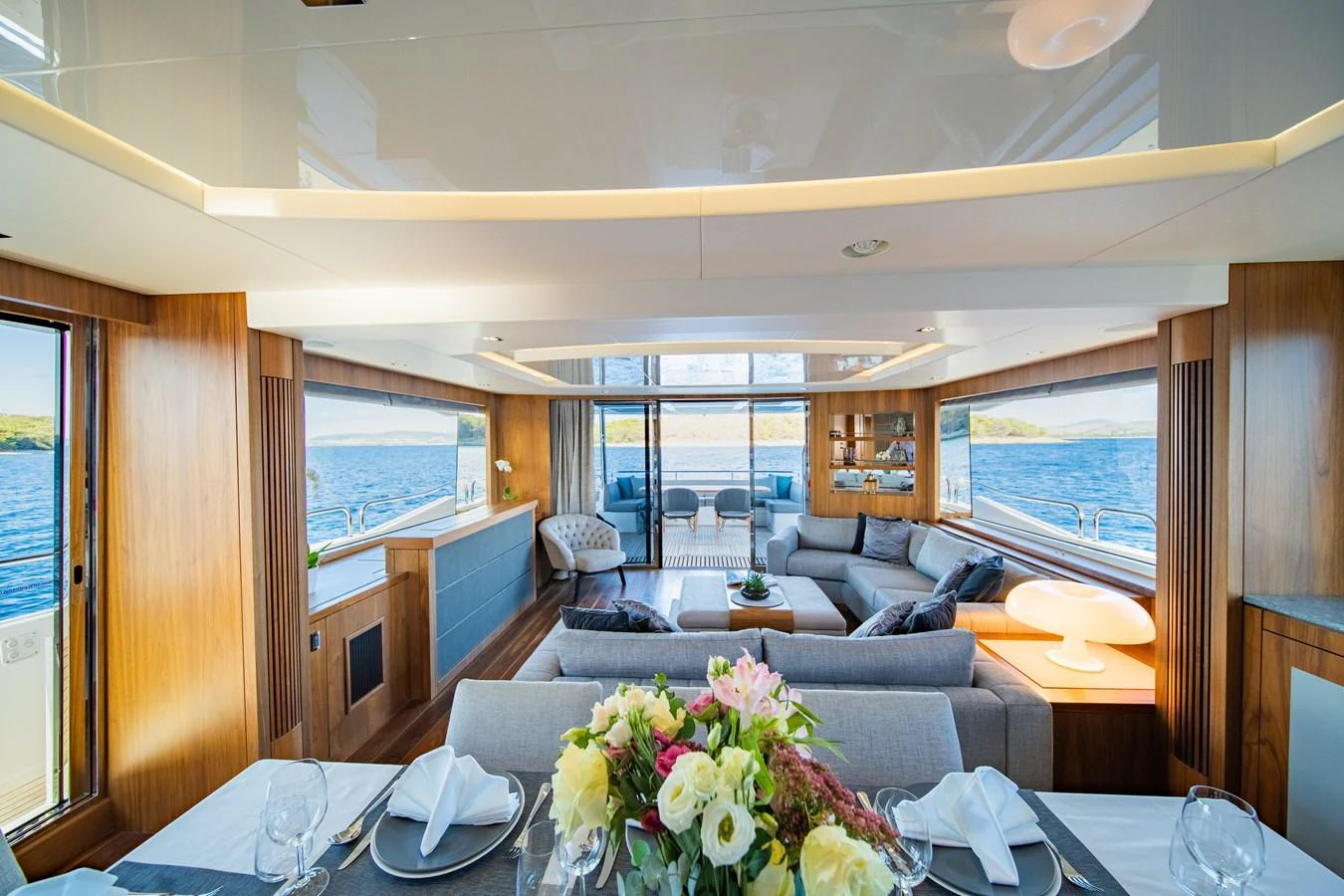 The spacious salon features elegant seating, a dining area, and panoramic views of the sea. aboard BLACK MAMBA Yacht for Sale