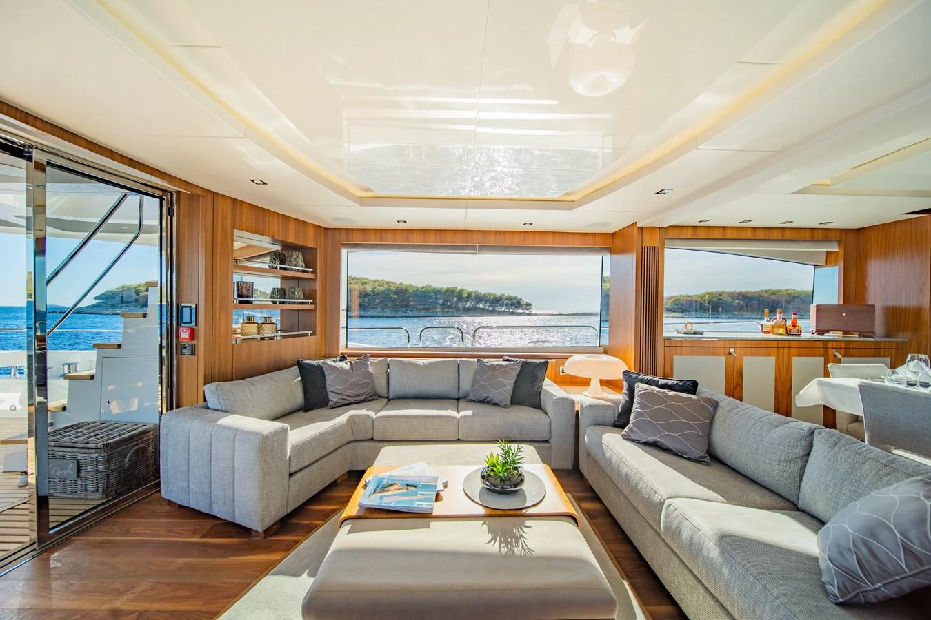The salon offers a spacious and inviting area with large windows providing stunning views of the surrounding waters. aboard BLACK MAMBA Yacht for Sale