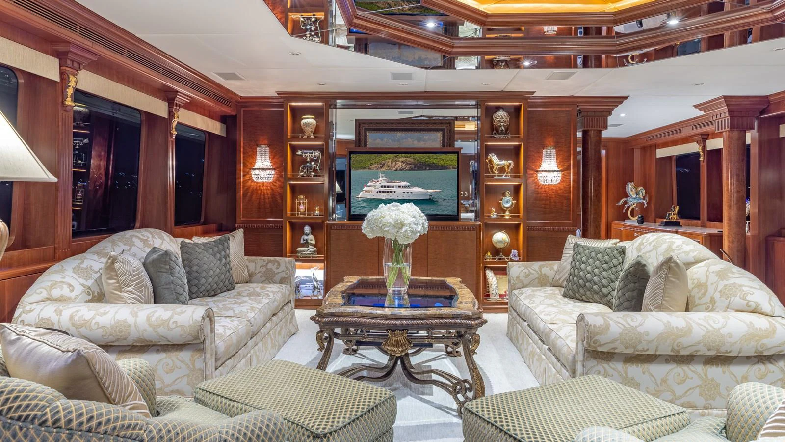 The yacht's salon features luxurious seating with elegant decor and a large TV for entertainment. aboard RELENTLESS Yacht for Sale