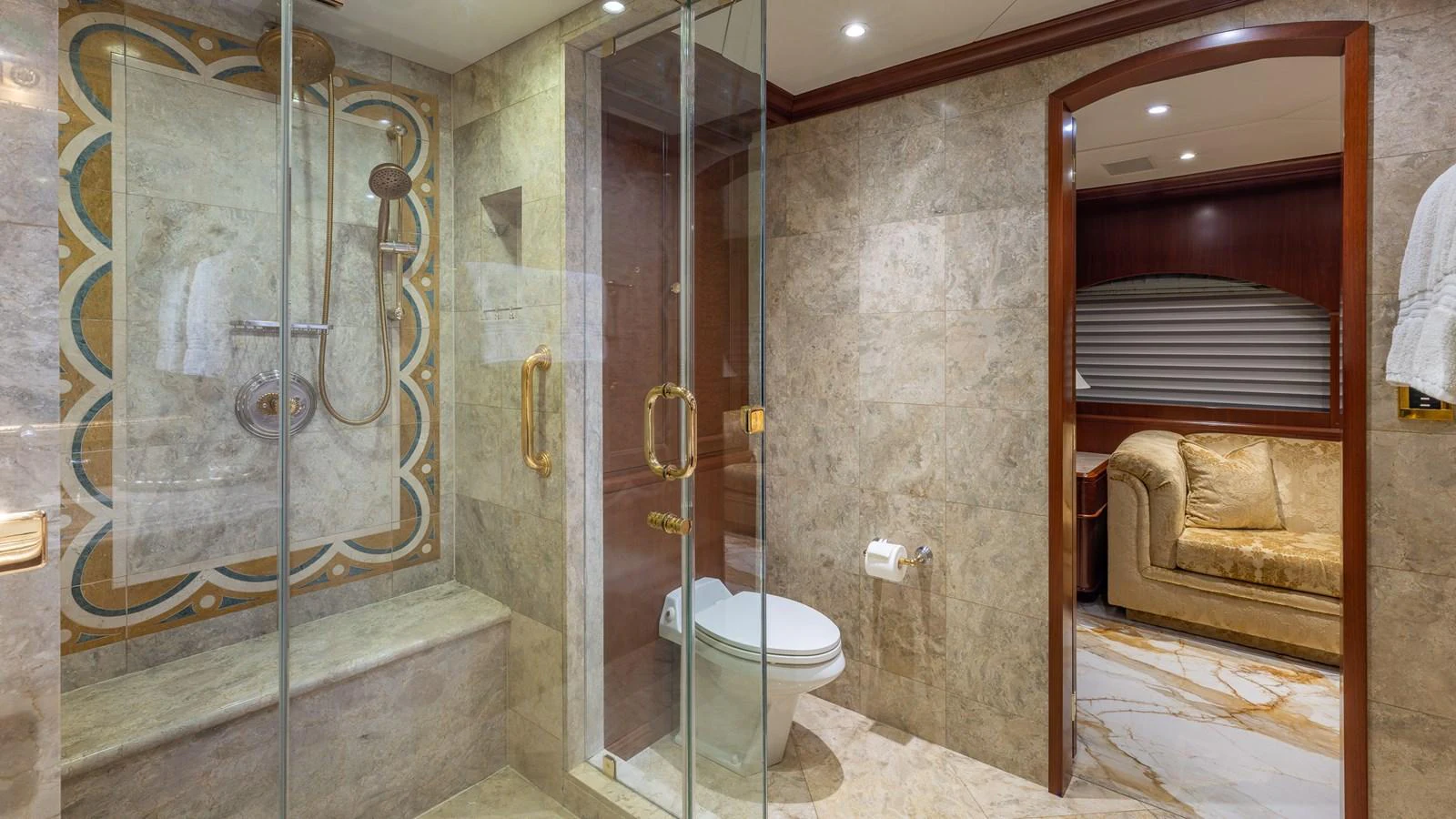 A luxurious bathroom with a glass-enclosed shower and elegant marble finishes. aboard RELENTLESS Yacht for Sale