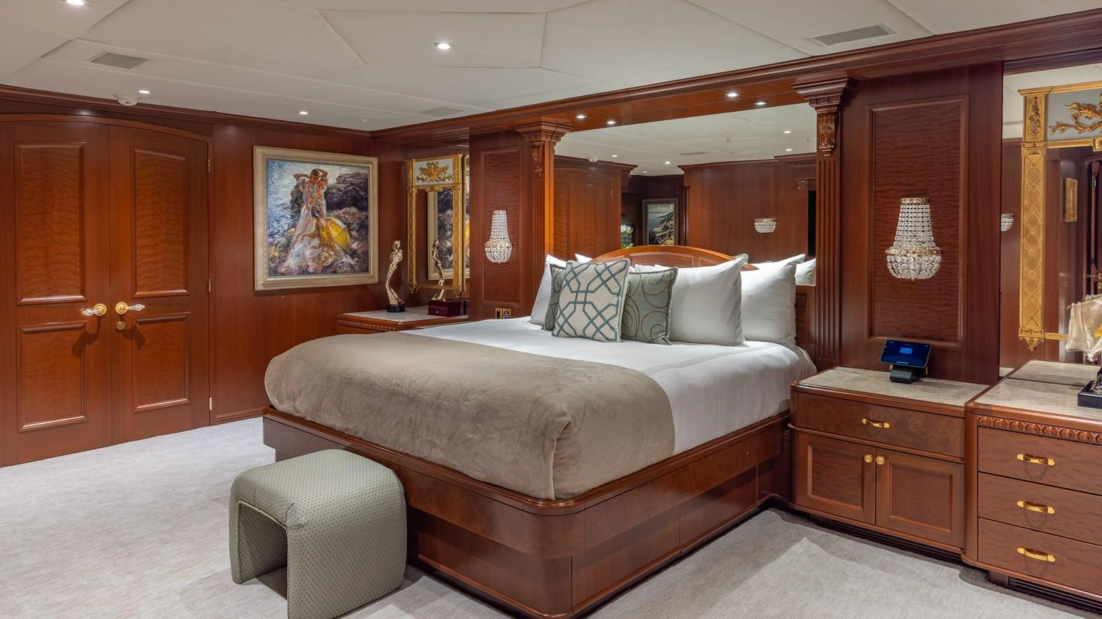 The master stateroom features luxurious wood paneling, a large bed, and elegant decor. aboard RELENTLESS Yacht for Sale