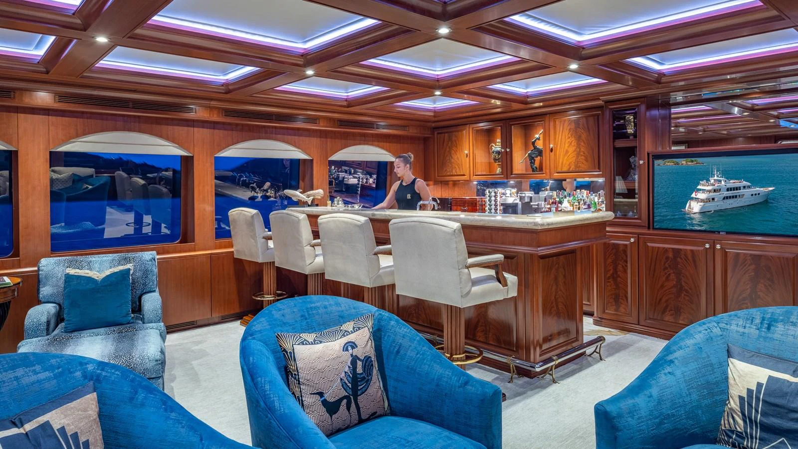 The luxurious saloon features a stylish bar area with plush seating and elegant wood finishes. aboard RELENTLESS Yacht for Sale