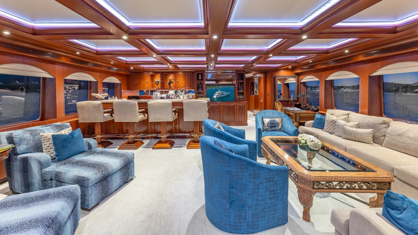 The yacht's salon features luxurious seating, elegant woodwork, and ambient lighting for a sophisticated atmosphere. aboard RELENTLESS Yacht for Sale