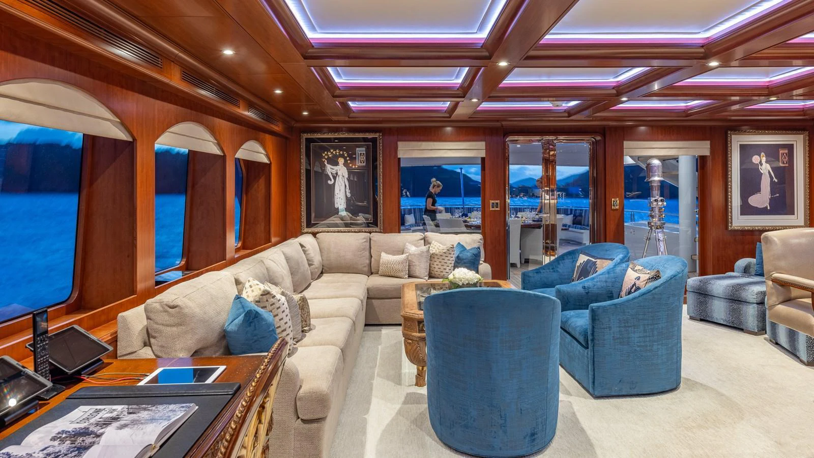 The salon features plush seating with elegant decor and large windows offering stunning views. aboard RELENTLESS Yacht for Sale