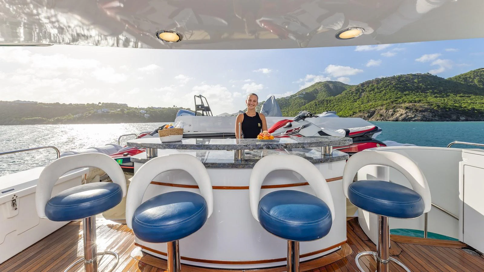 An inviting outdoor bar area on the yacht, featuring comfortable seating and a scenic backdrop. aboard RELENTLESS Yacht for Sale