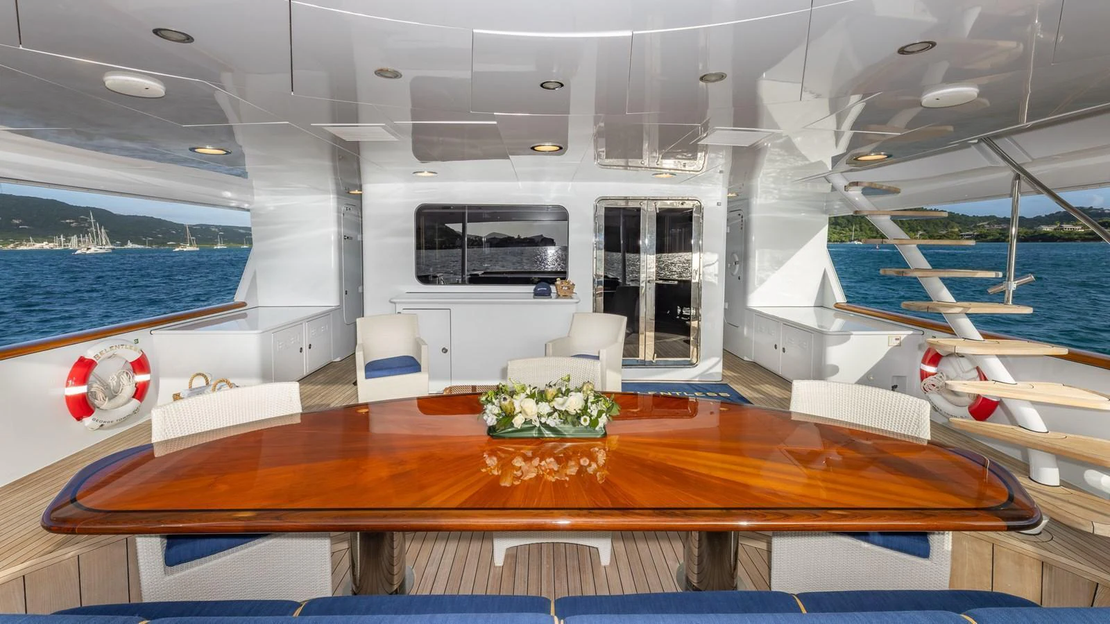 The aft deck offers a spacious and elegant dining area with a stunning view of the surrounding waters. aboard RELENTLESS Yacht for Sale