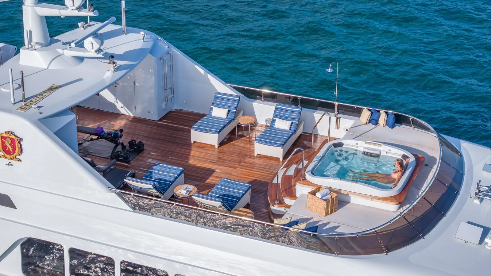 The sundeck features luxurious lounge chairs, a jacuzzi, and a stunning view of the ocean. aboard RELENTLESS Yacht for Sale