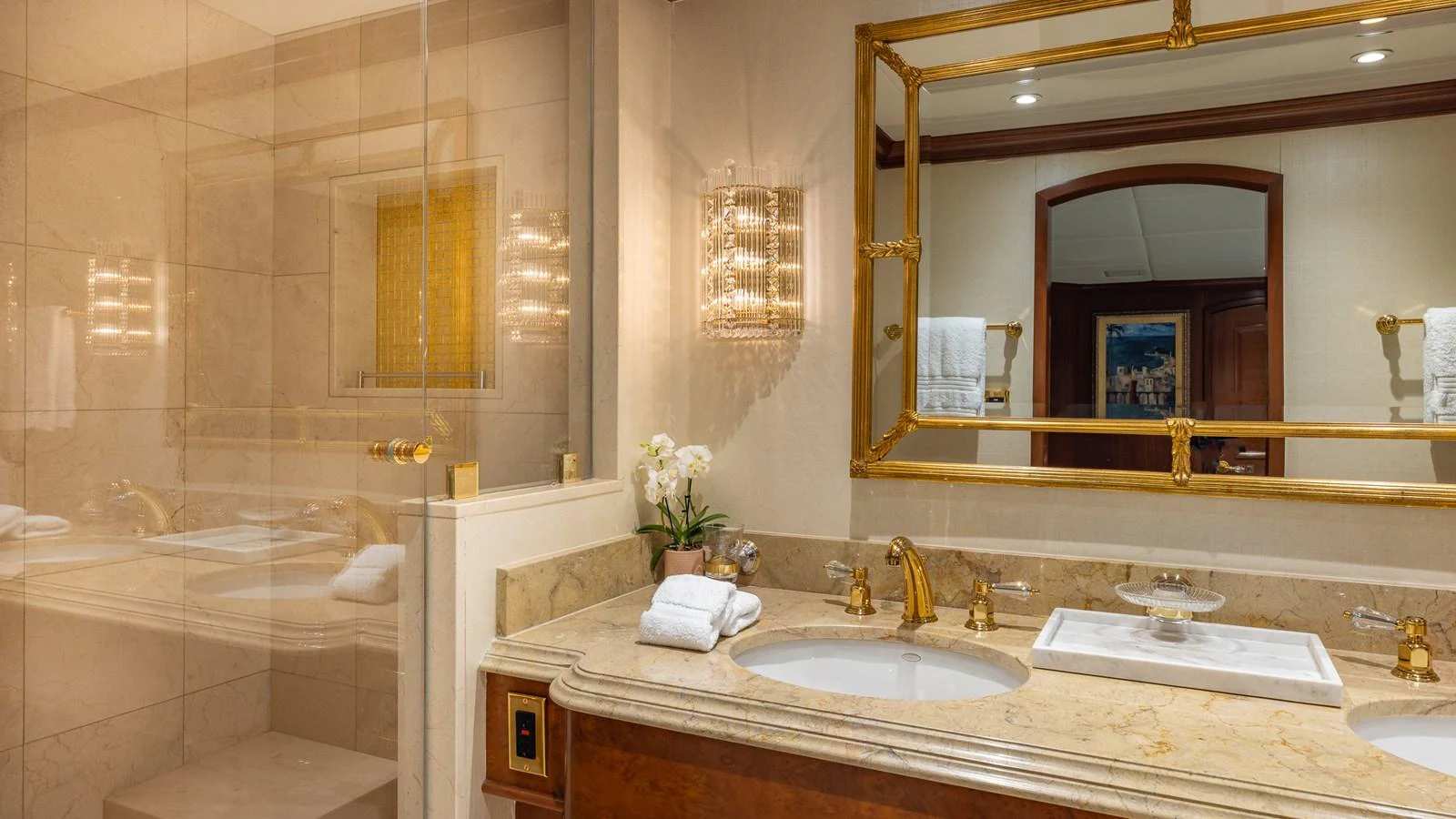 The luxurious bathroom features elegant fixtures, a spacious shower, and a double vanity with a large mirror. aboard RELENTLESS Yacht for Sale