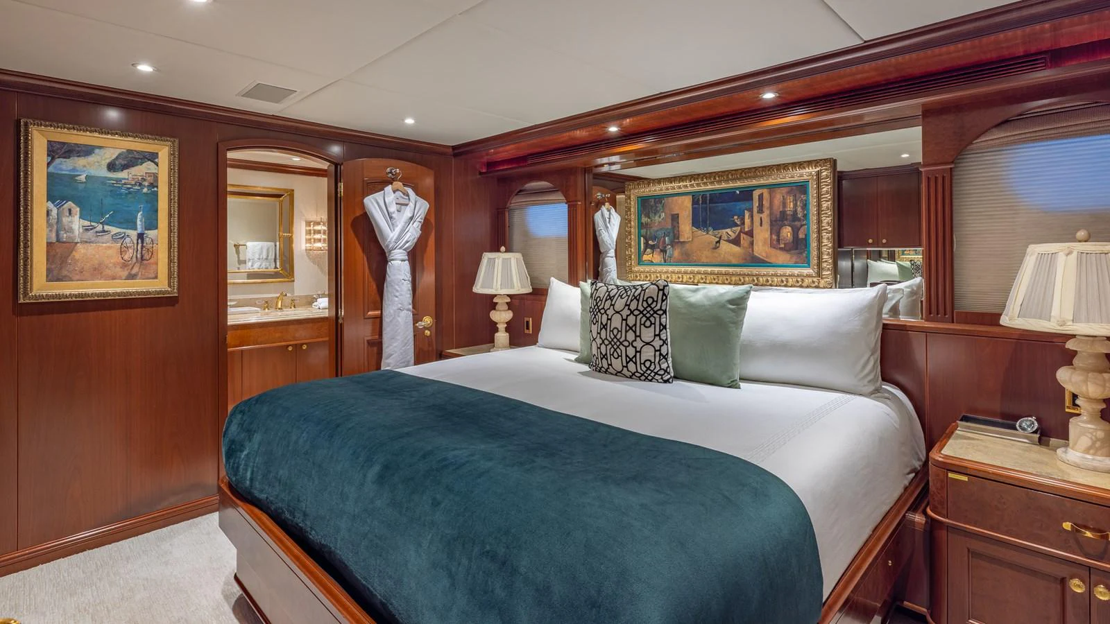 The master stateroom features a luxurious bed with elegant decor and ample lighting. aboard RELENTLESS Yacht for Sale