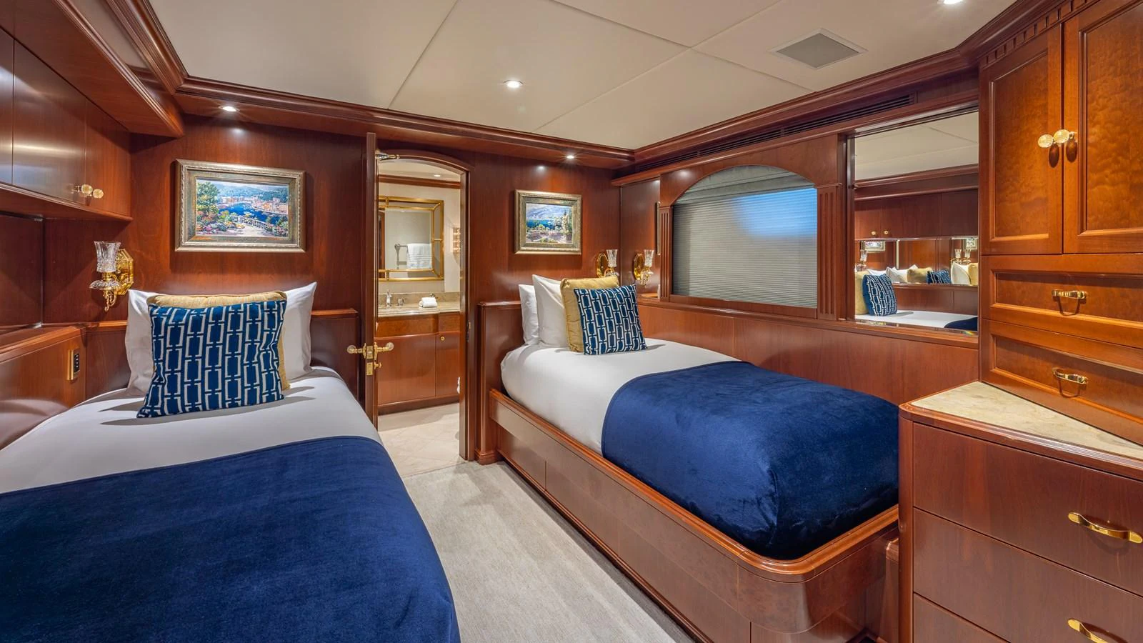 The twin stateroom features elegant wood paneling and luxurious bedding, creating a cozy and refined atmosphere. aboard RELENTLESS Yacht for Sale