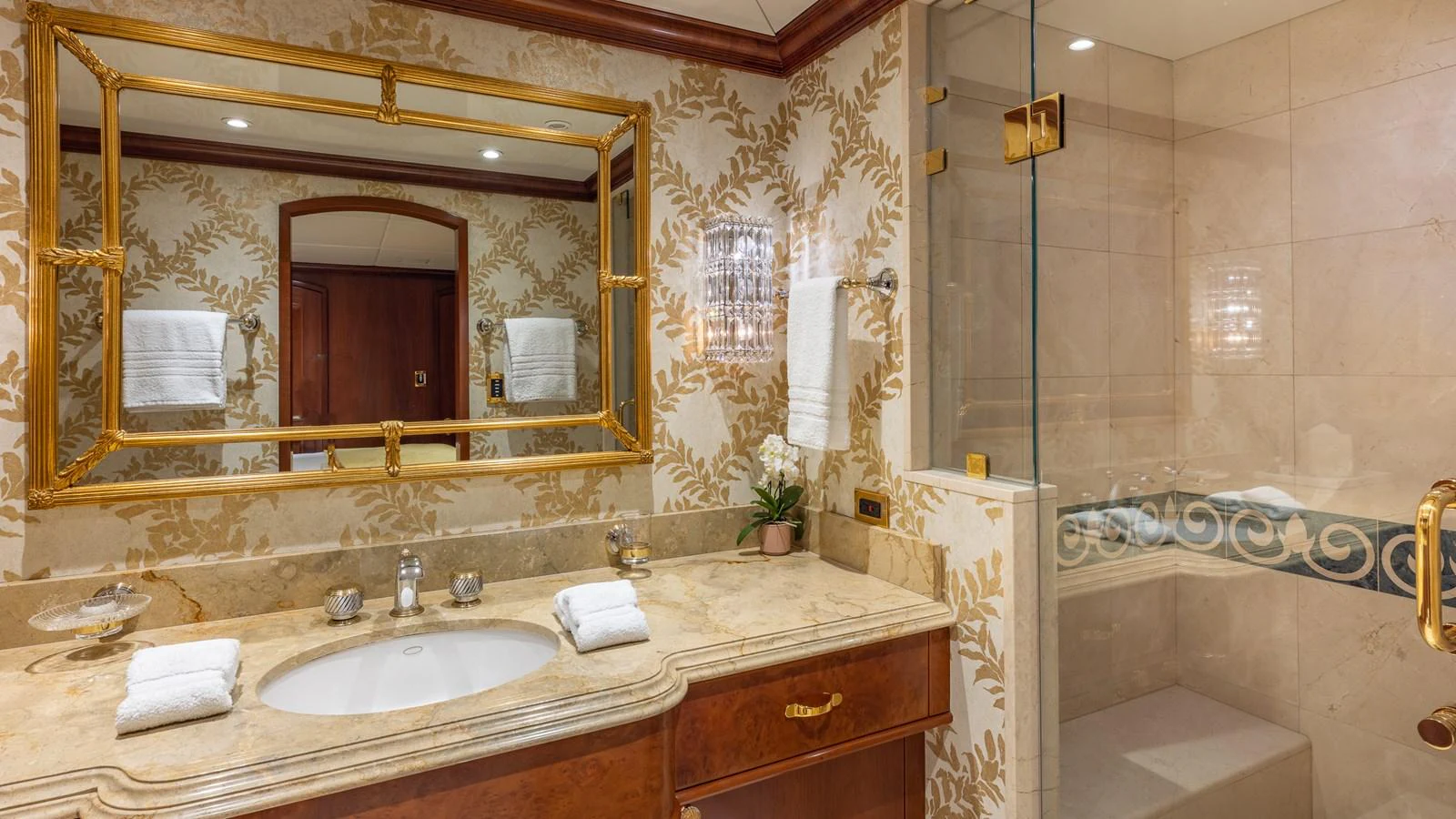 The yacht's bathroom features elegant decor with a large mirror and a spacious shower area. aboard RELENTLESS Yacht for Sale