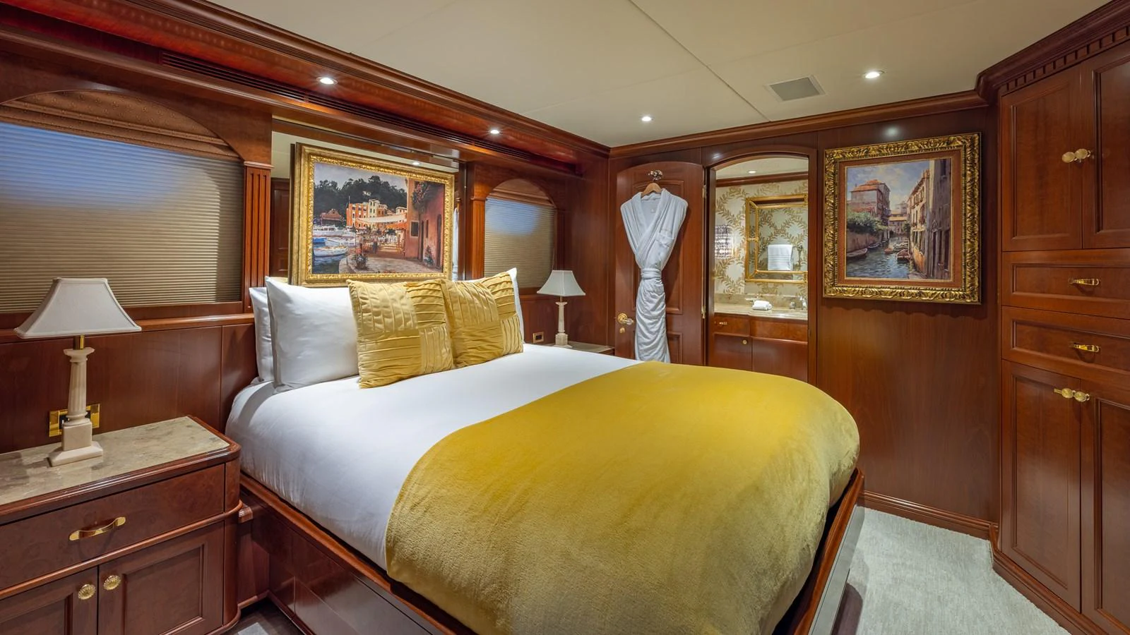 The master stateroom features a luxurious bed with elegant wood paneling and tasteful artwork. aboard RELENTLESS Yacht for Sale