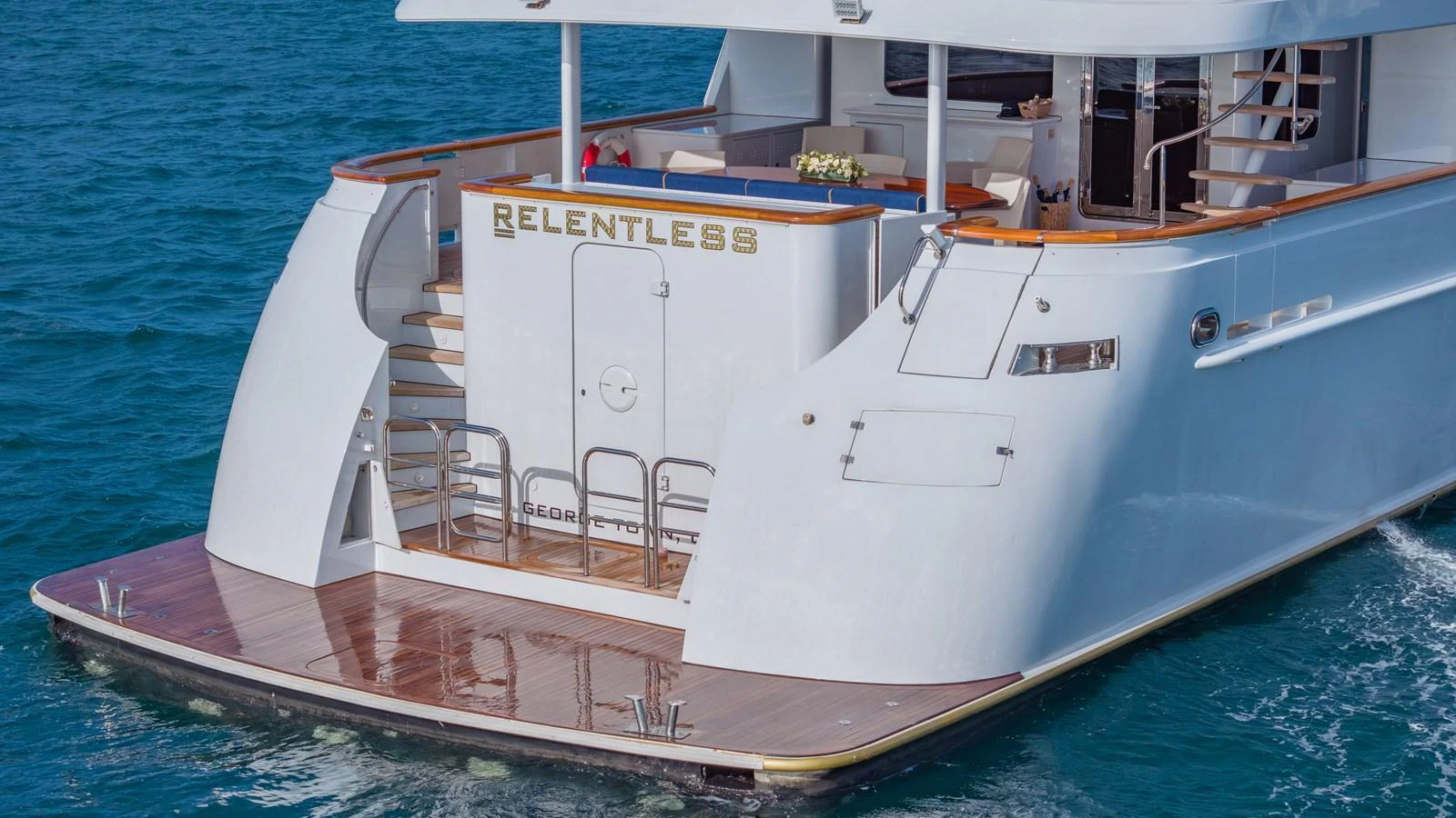 The aft deck of this yacht features a spacious swim platform and elegant design details. aboard RELENTLESS Yacht for Sale