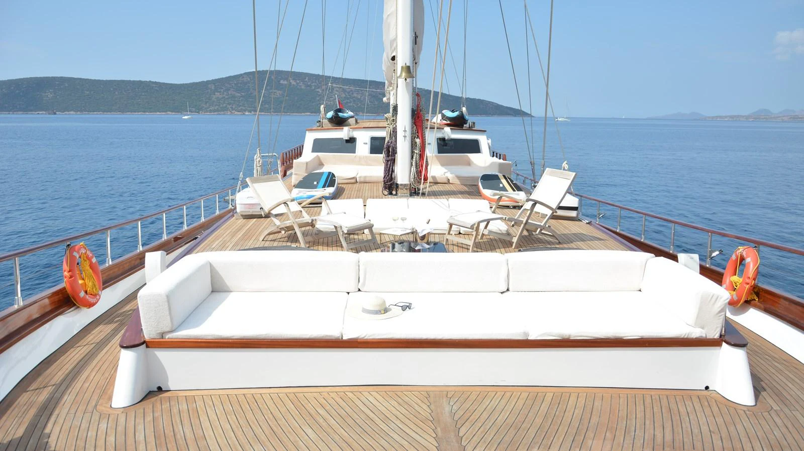The foredeck offers a spacious lounging area with comfortable seating and sun loungers, perfect for relaxation while enjoying the sea view. aboard PAPA JOE Yacht for Sale