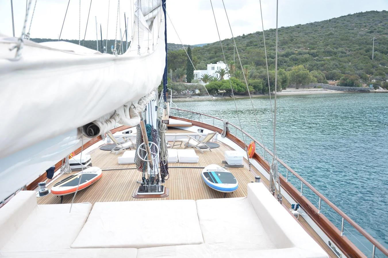 The yacht's deck offers a spacious and inviting area for relaxation and activities, with paddleboards and comfortable seating. aboard PAPA JOE Yacht for Sale