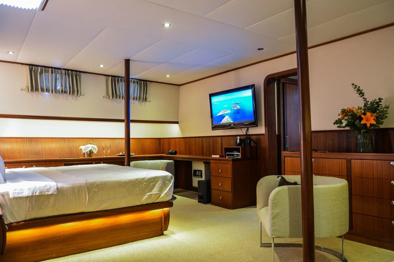 A luxurious stateroom featuring a comfortable bed, modern amenities, and elegant decor. aboard PAPA JOE Yacht for Sale