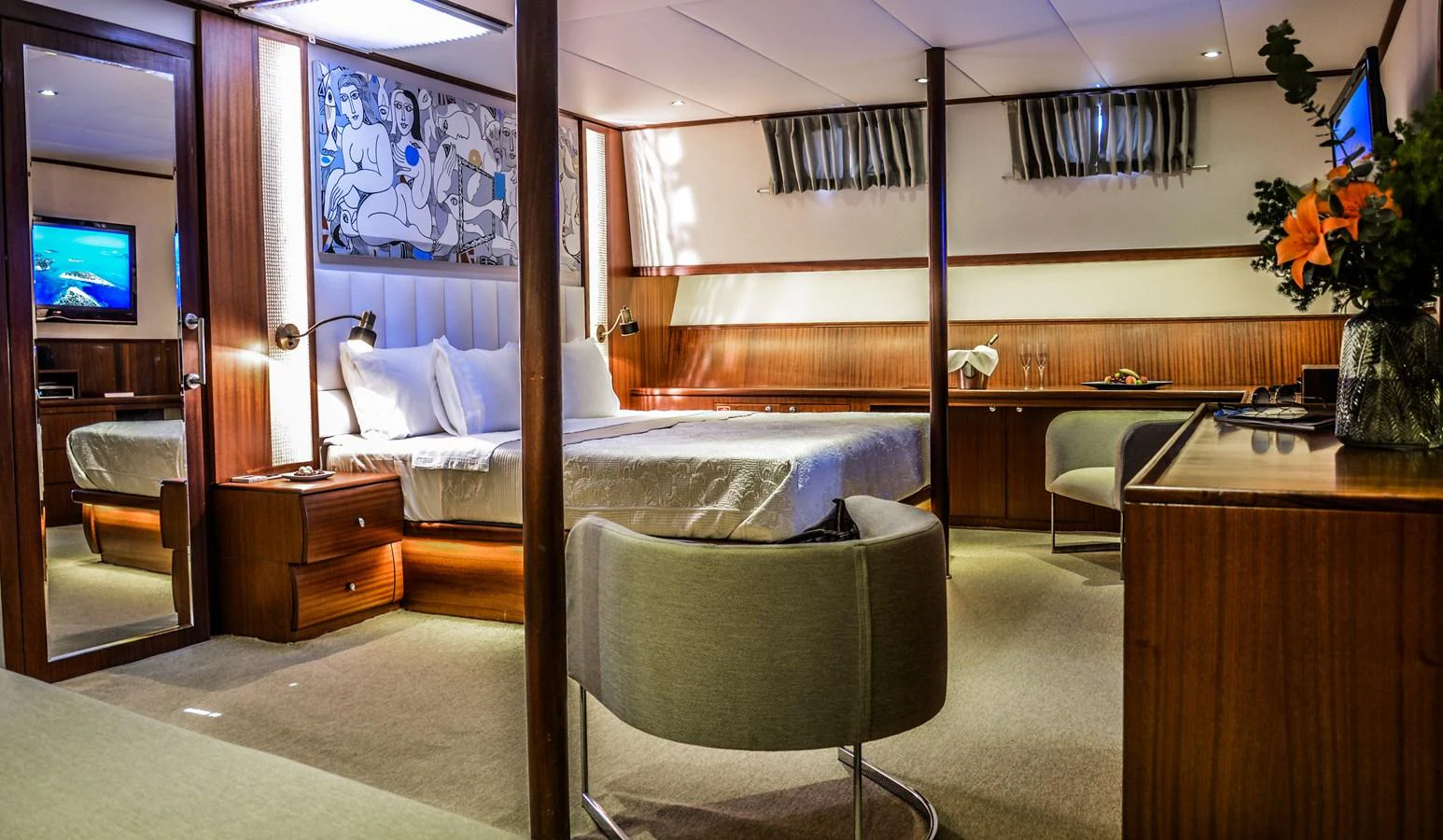 The master stateroom features a luxurious bed, elegant wood finishes, and modern amenities for ultimate comfort. aboard PAPA JOE Yacht for Sale