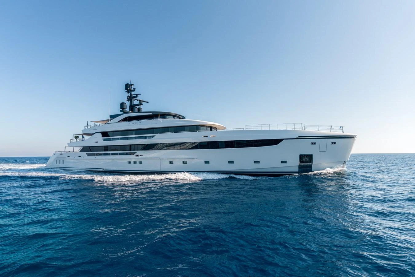 A sleek and modern yacht glides effortlessly across the open sea. aboard ALCHEMIST Yacht for Sale