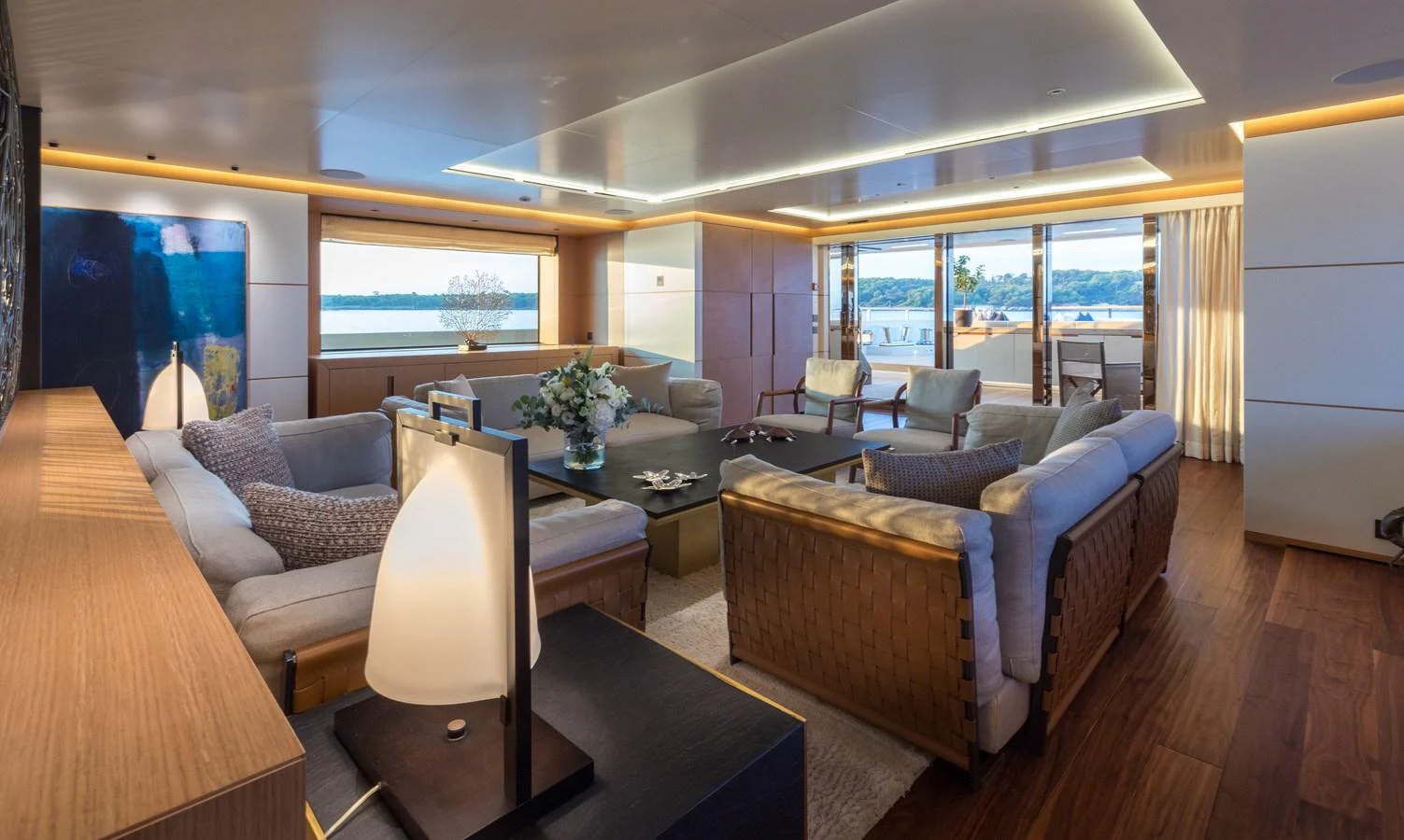 The salon offers a spacious and elegant setting with ample seating and large windows for panoramic views. aboard ALCHEMIST Yacht for Sale