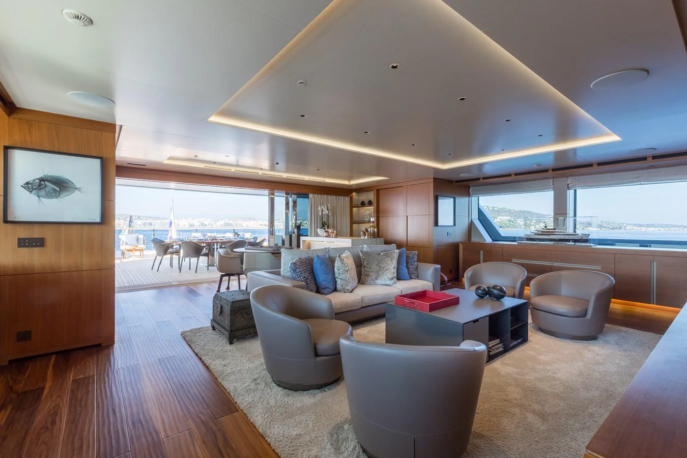 The spacious salon features modern furnishings and expansive windows offering stunning views. aboard ALCHEMIST Yacht for Sale