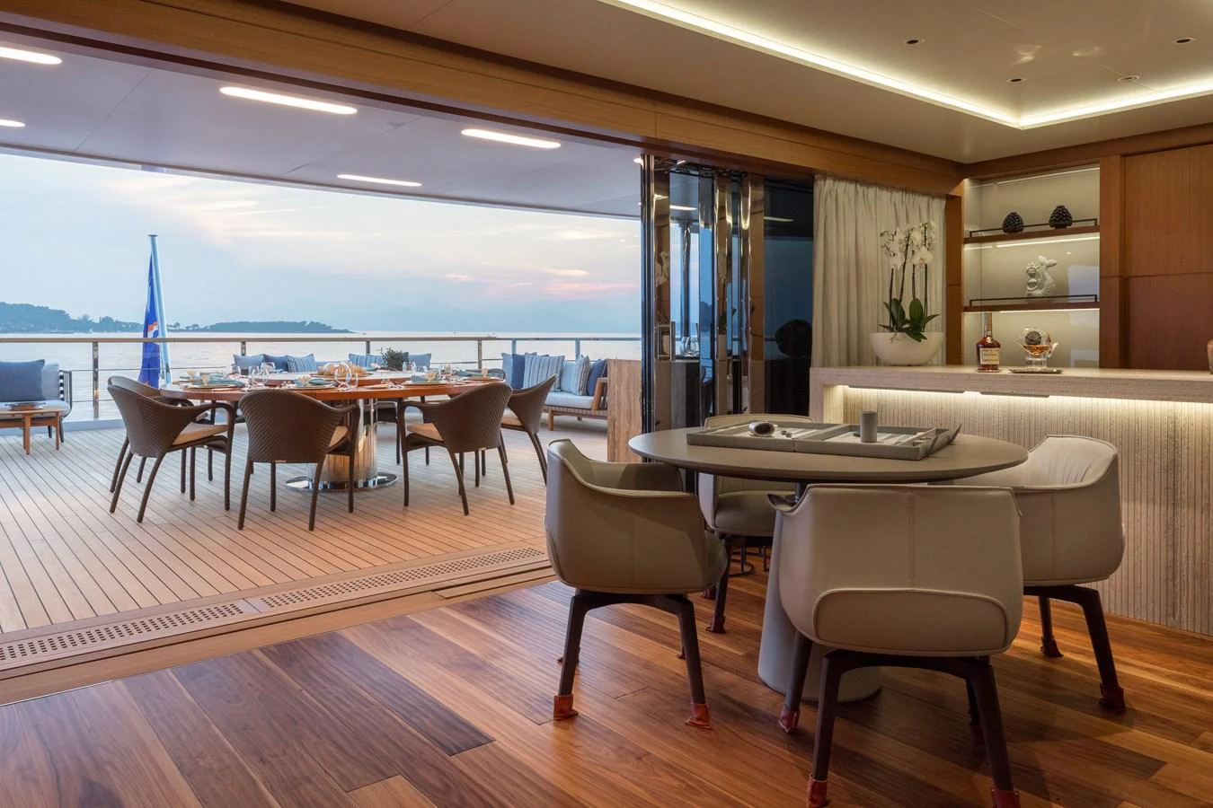 This elegant dining area seamlessly connects to the aft deck, offering stunning views and luxurious comfort. aboard ALCHEMIST Yacht for Sale
